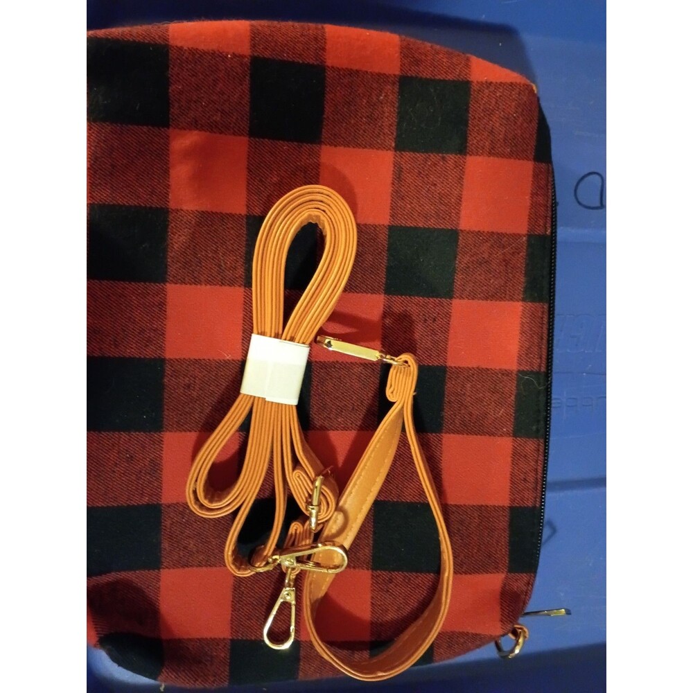 Buffalo plaid crossbody purse includes a detachable orange strap